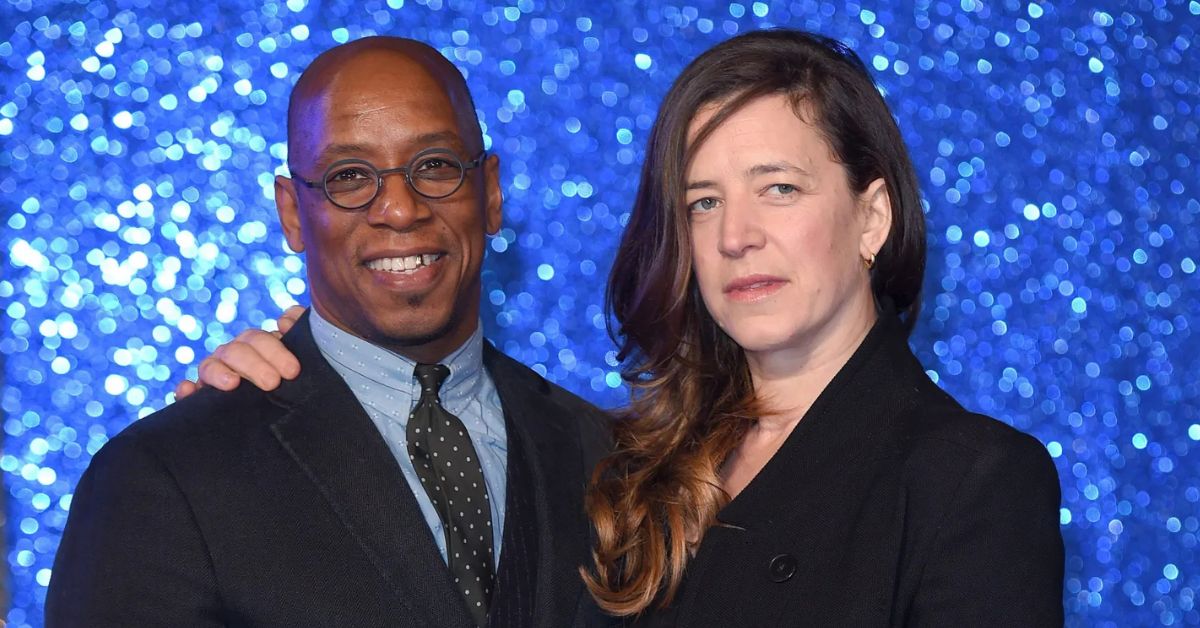 Nancy Hallam standing beside her husband during a community event, both looking confident and happy together.