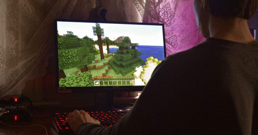 Player exploring Minecraft terrain on PC, focusing on building and survival gameplay.