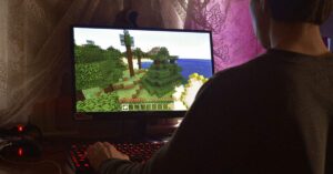 Player exploring Minecraft terrain on PC, focusing on building and survival gameplay.
