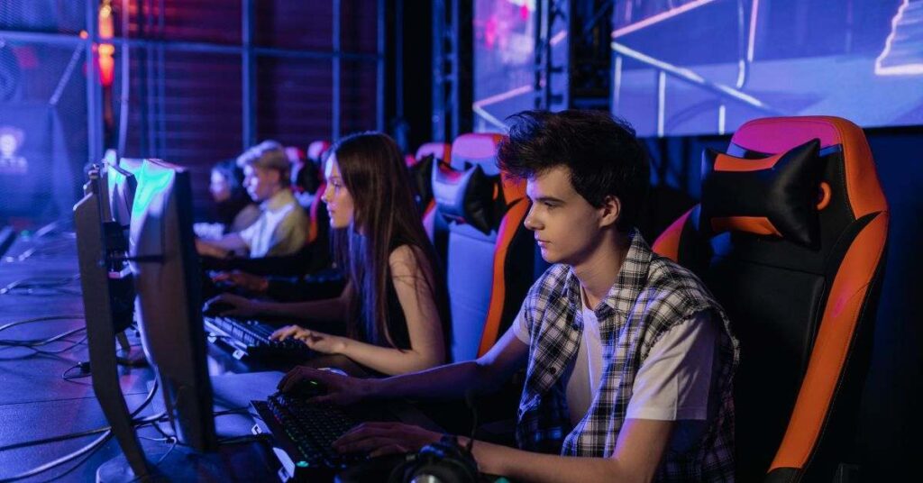 Gaming room with desktop computer displaying Minecraft, surrounded by keyboard and accessories.