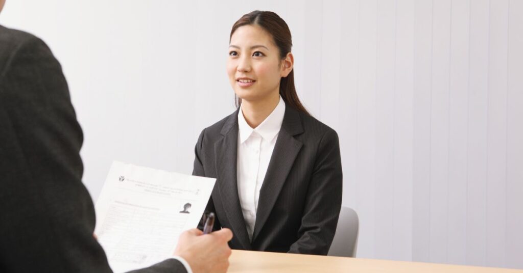 Job interview between candidate and interviewer reviewing resume.