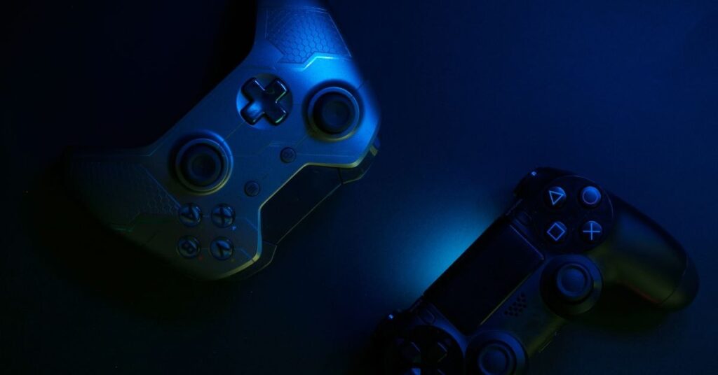 Two gaming controllers in dark neon blue lighting, close-up view.