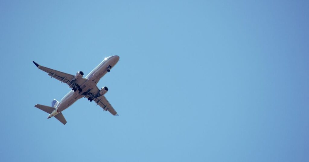 Airplane flying in clear blue sky during daytime.